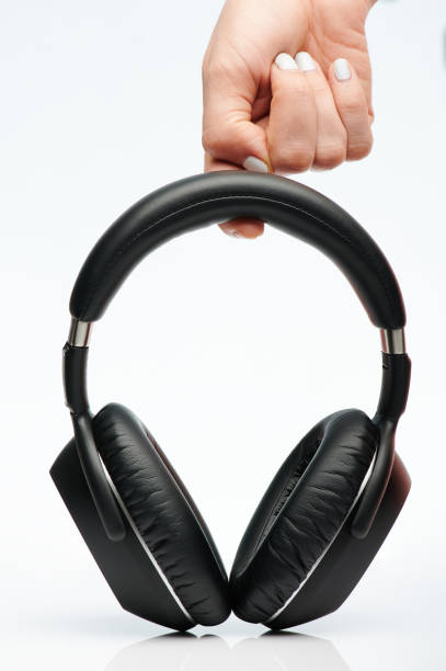 istock Hand hold black headphones 1152105820