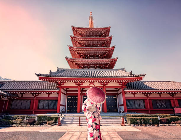 Architecture in Tokyo February 2019 - Tokyo, Japan - Girl with traditional dress in Senso-ji temple in Asakusa, Tokyo shinto photos stock pictures, royalty-free photos & images