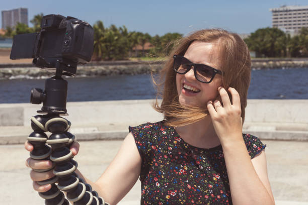 istock Camera recording a young caucasian female blogger gesturing while making a video 1152107290