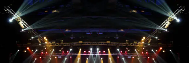 Performance moving lighting on construction light beam ray downward in yellow blue color, on Concert and Fashion Show stage ramp. LED par new technology to save power more color and high density Light