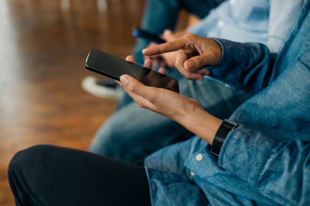 istock Young business people using smartphone on wooden table share data and send messages in groups, technology concept