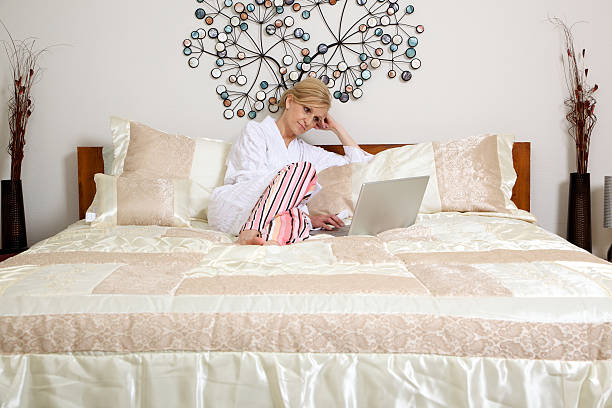 istock female bedroom laptop morning 115211426