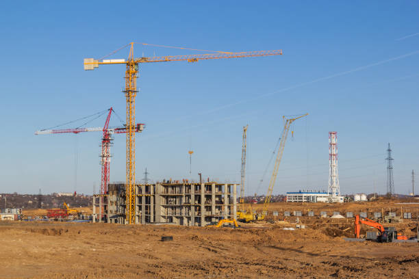 istock Construction of a multi-storey building on a wasteland 1152115224