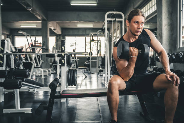 istock Young handsome man doing exercises in gym. 1152118097