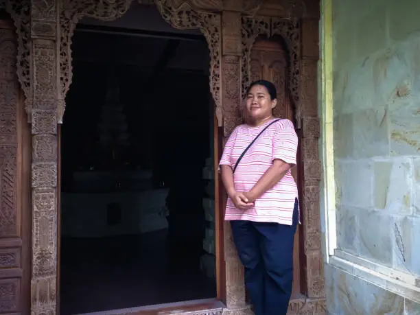 Woman Traveler In Front Of The Door Of Dark Room Of Buddhist Meditation Place At Buddhist Temple, North Bali, Indonesia