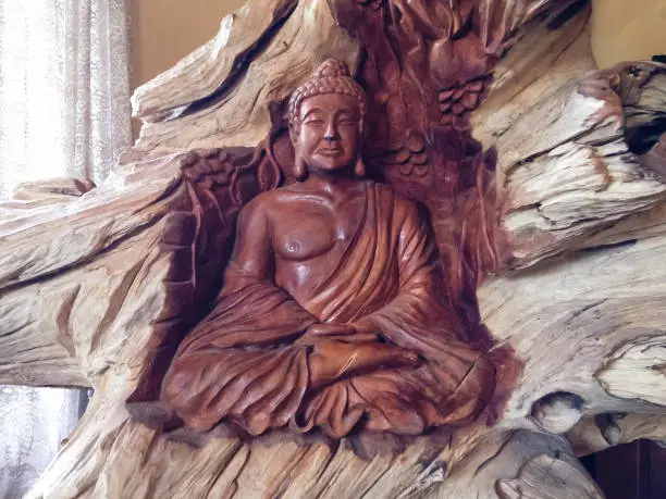 Carved Buddha Statue On Large Pieces Of Wood In The Buddhist Monastery Room In Bali, Indonesia