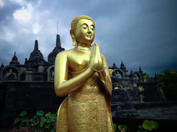 Golden Standing Buddha Statue And Buddhist Temple Building In The Cloudy Sky At Banjar Tegeha Village, North Bali, Indonesia