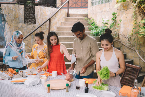 istock a group of asian multi ethic young adults gathering at villa during weekend for city break enjoying barbecue food preparing session 1152122467