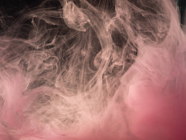 istock Pink acrylic paint dissolving into water, abstract pattern. Close up view. Blurred abstract background. Ink dropped into liquid. Paint mixing with water. Acrylic smoke under water. Abstract art. 1152122559