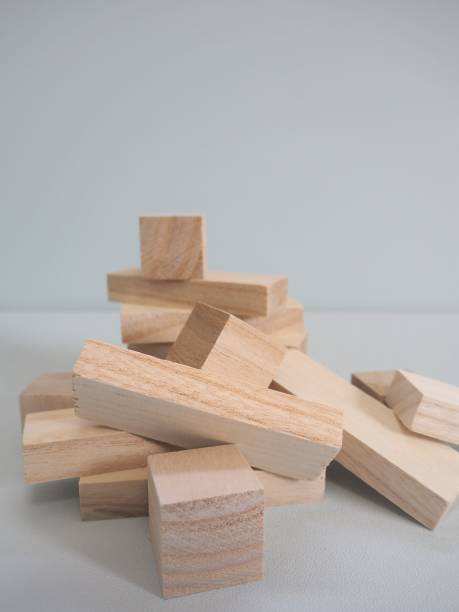 istock Stacked wooden toy blocks collapsing 1152124877