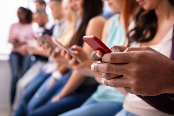 istock Row Of Young People Using Cellphones 1152125062