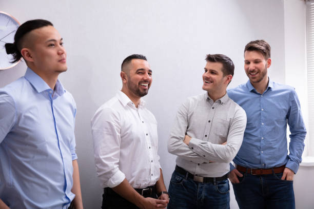 istock Group Of Smiling Businessmen Standing In Office 1152125070