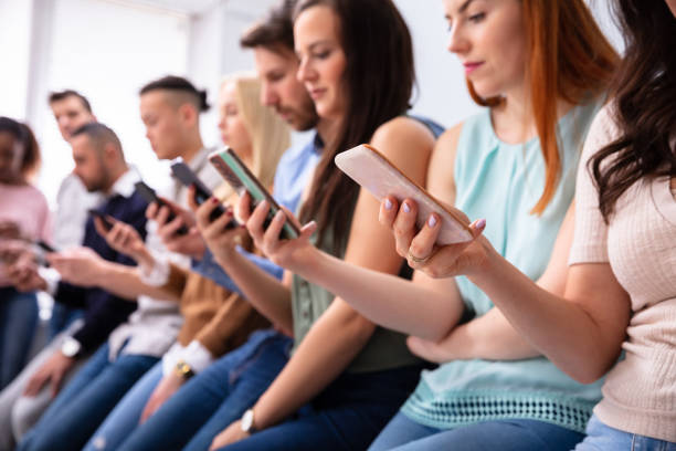 istock Row Of Young People Using Cellphones 1152125073