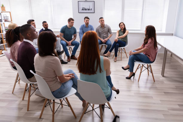 istock Female Therapist Speaking To Group At Therapy Section 1152125081