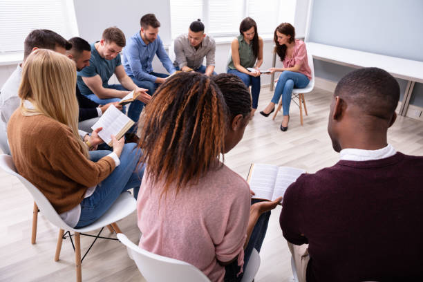 istock Group Of Young People Reading Bible Together 1152125097