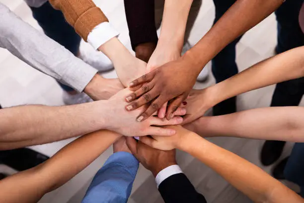 Photo of Diverse People Stacking Hand Together