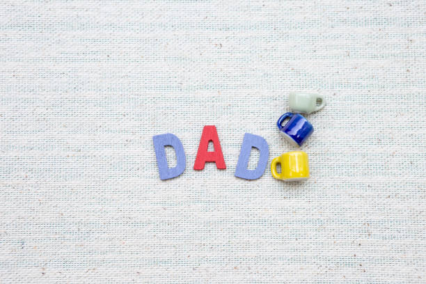 istock Dad wooden text with miniature coffee cup on canvas fabric texture background 1152127212