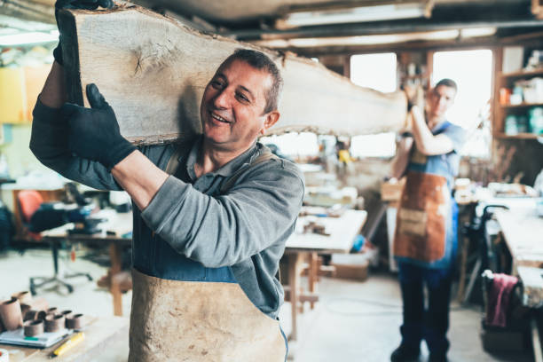 istock Carpenters carrying A Wooden Plank 1152127653
