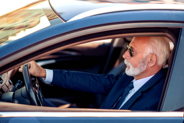 istock Senior businessman driving a car 1152131381
