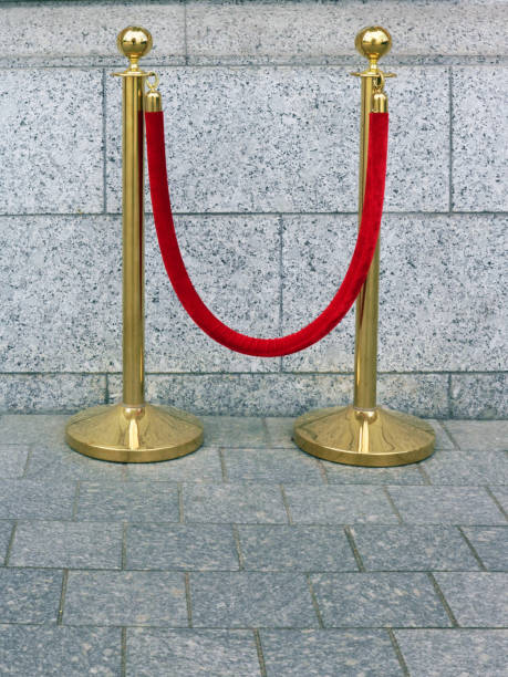 istock Thick velvet red rope barrier and bronze racks 1152132123