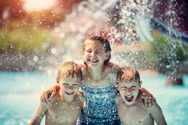 Kids having fun in pool in a waterpark. Laughing and screaming being splashed with cold water.
Nikon D850