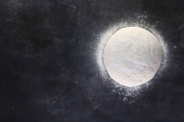 fresh dough for making pizza and bread on the table black background. top view, copy space for your text, meru, recipe. - dough sphere kneading bread imagens e fotografias de stock