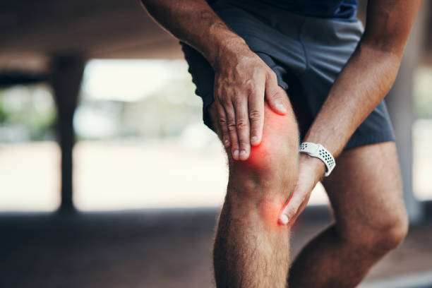 He took some pressure to the knee Closeup shot of an unrecognizable man holding his knee in pain while exercising outdoors center athlete stock pictures, royalty-free photos & images