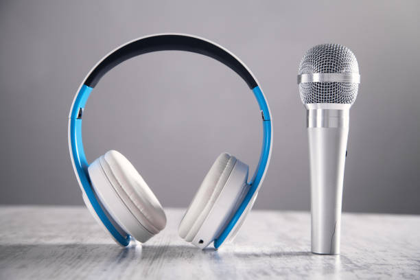 istock Microphone and headphones on a white desk. 1152134808