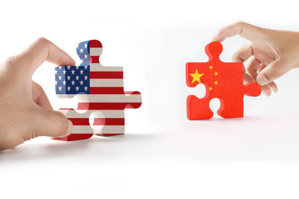 Wooden handle, jigsaw puzzle, United States flag and Chinese flag, isolated on white stock photo