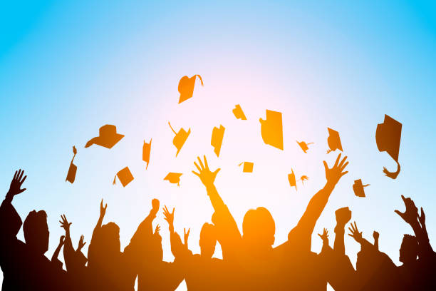 happy students throwing graduation caps in the Air