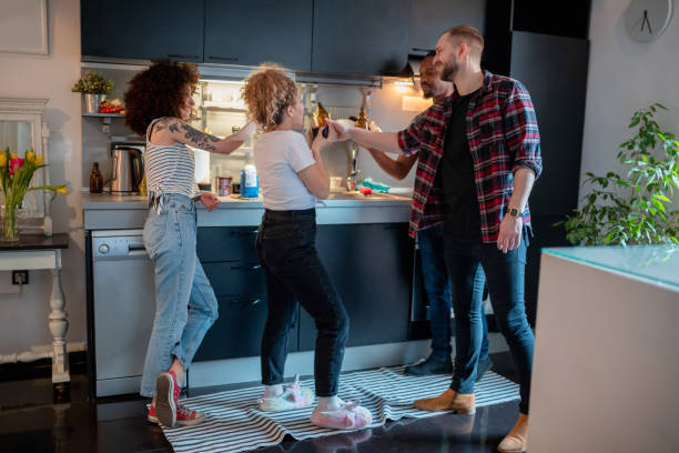 istock Flatmates cheering with beer in the kitchen 1152136988