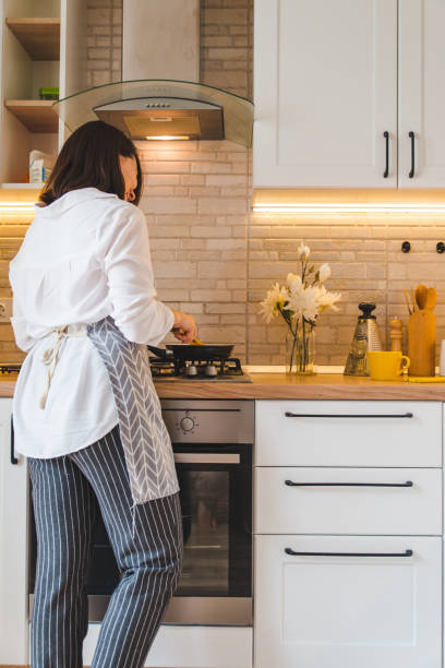 istock view from behind woman on kitchen cooking 1152137869