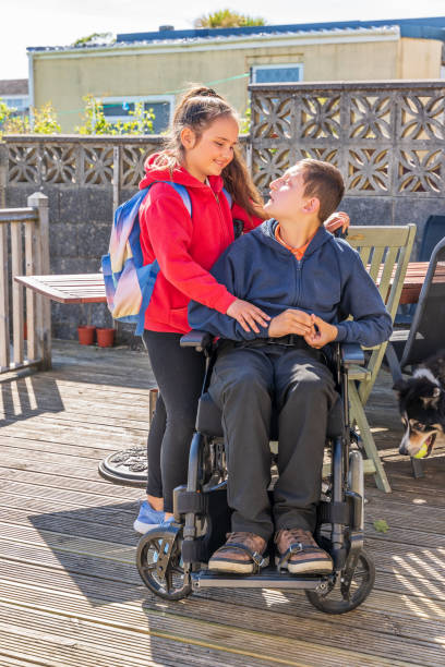 istock Young carer with boy in wheelchair 1152139411