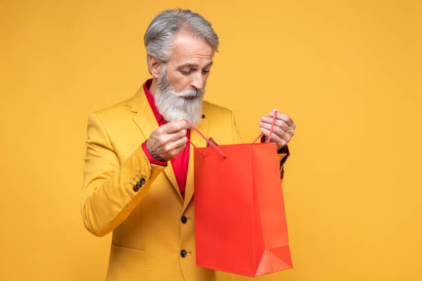 Happy well dressed gentleman with shopping bags