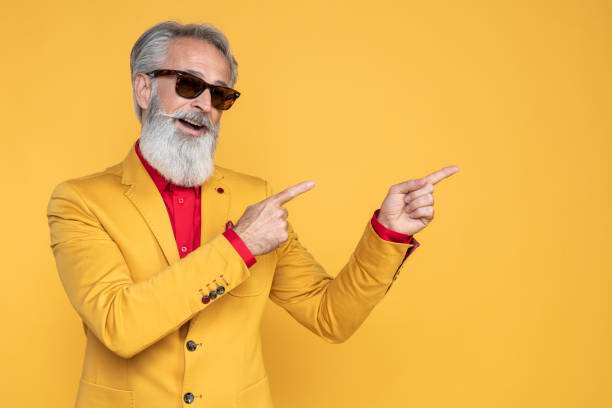 Happy well dressed gentleman having photoshooting in studio