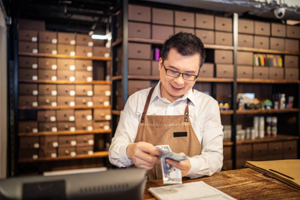 istock Small business owner counting money 1152140610