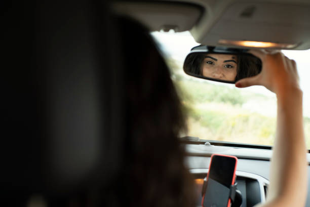 istock Woman adjusting the rear view mirror 1152142791