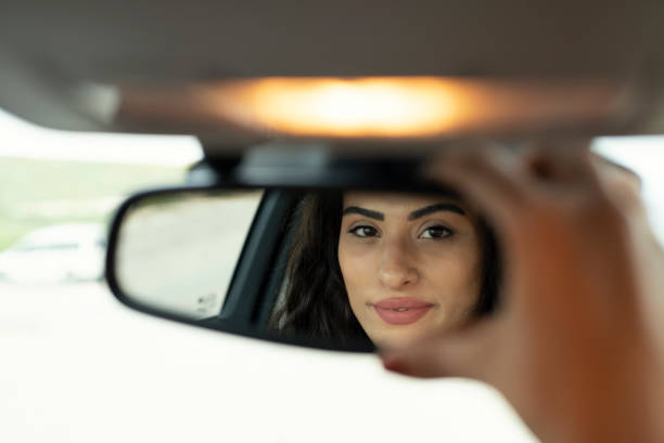 istock Woman adjusting the rear view mirror 1152142793