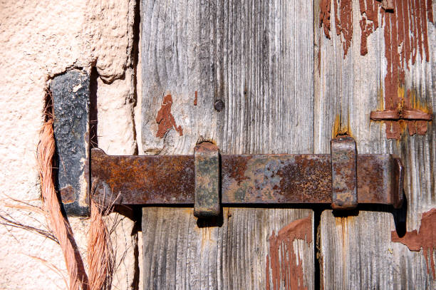 istock Old wooden gate with rusted iron fittings 1152144645