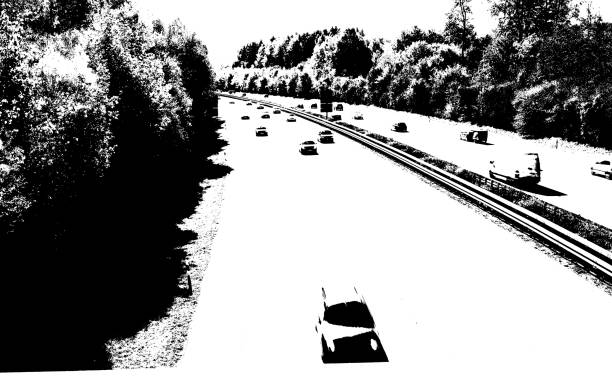 Multi-lane expressway with forest in black and white
