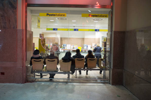 people seat down are waiting his turn at the italian post office - travel passenger milan italy italy imagens e fotografias de stock