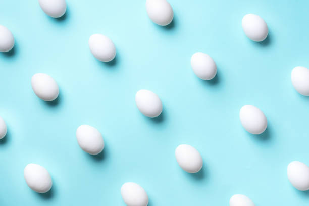 istock Food concept with white chicken eggs on blue background. Top view. Creative pattern in minimal style. Flat lay. 1152145686