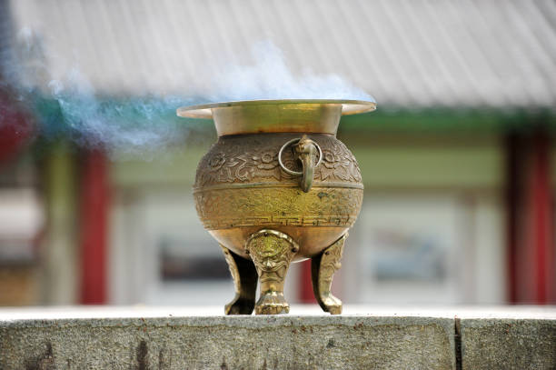 The bronze incense burner and smoke.