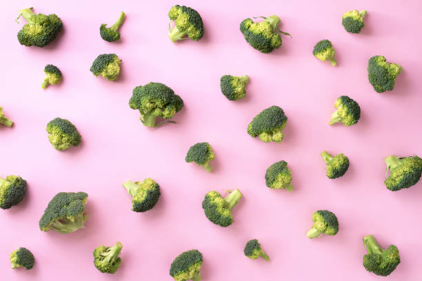 istock Creative layout of fresh broccoli on pink paper background. Top view. Food pattern in minimal style. Flat lay. 1152146129