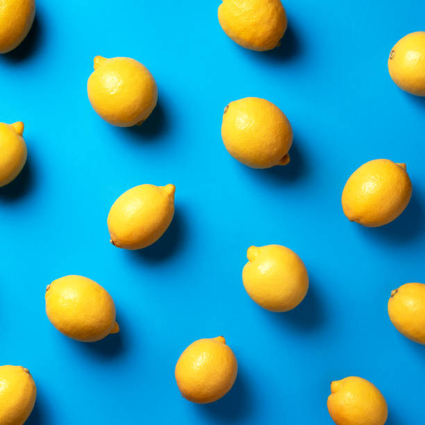 istock Food pattern with lemons on blue paper background. Top view. Summer concept. Vegan and vegetarian diet. Square crop 1152146143