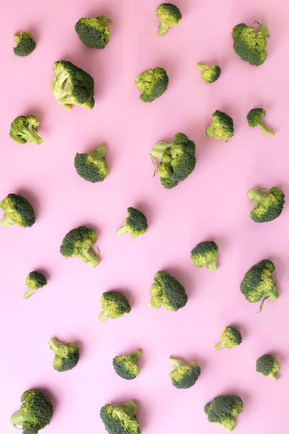 istock Creative layout of fresh broccoli on pink paper background. Top view. Food pattern in minimal style. Flat lay. 1152146157