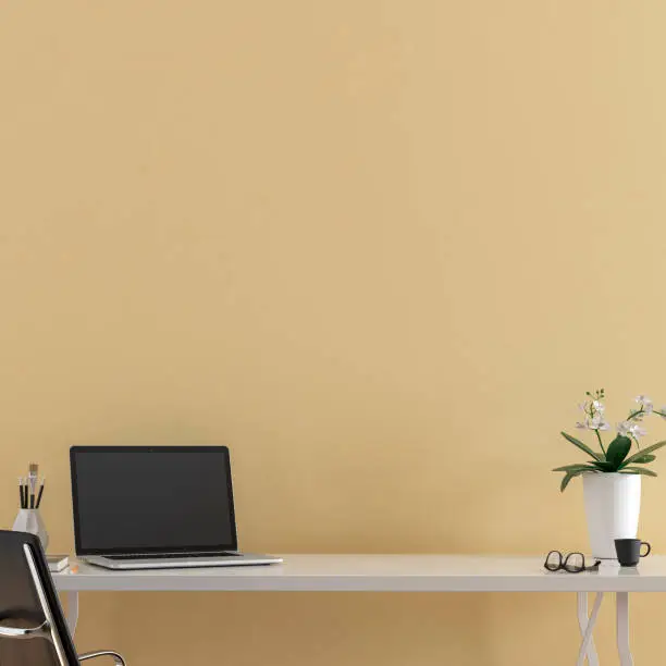Workdesk with decoration in front of empty beige wall with copy space. 3D rendered image.
