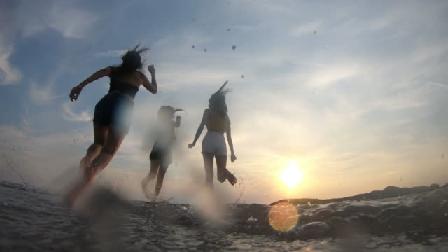 4K resolution slow-motion Asian woman happy Group Friends enjoy summer vacation and funny Running on the beach