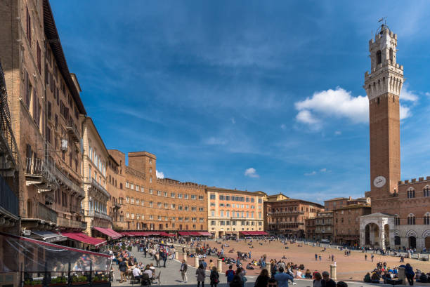 Torre del Mangia and town hall on Siena town square - Piazza del Campo. Photo taken early in the morning.