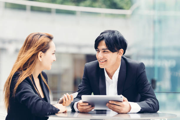 istock Two young people making business together 1152154640